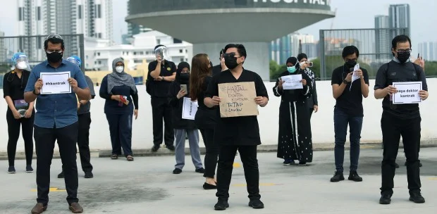 students holding up placards in protest